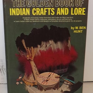 May include: A hardcover book titled "THE GOLDEN BOOK OF INDIAN CRAFTS AND LORE" with a green cover. The cover features illustrations of Native American crafts and a feathered headdress. The author's name, W. Ben Hunt, is also visible.