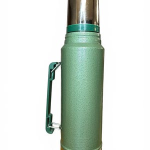 May include: A trio of ceramic mugs with a speckled, matte finish in cream, light grey, and dark grey. Each mug features a simple, minimalist design, ideal for tea or coffee.