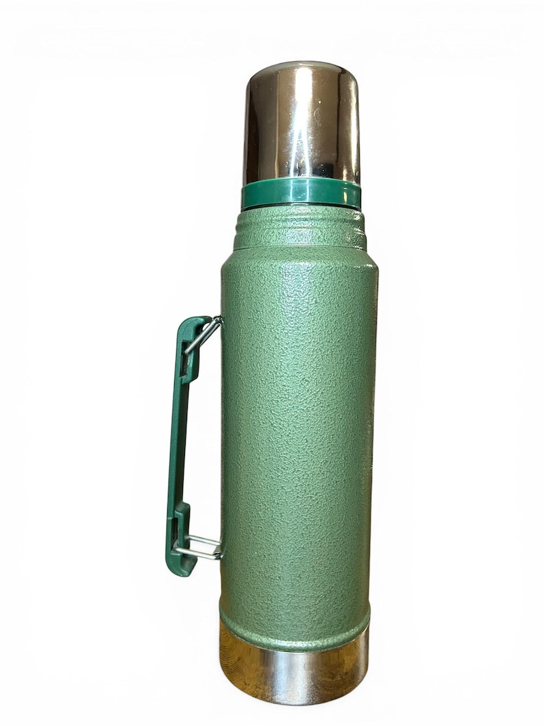 May include: A trio of ceramic mugs with a speckled, matte finish in cream, light grey, and dark grey. Each mug features a simple, minimalist design, ideal for tea or coffee.