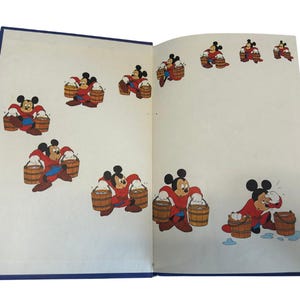 May include: Open book with illustrations of Mickey Mouse in a red outfit carrying wooden buckets. The cartoon character is depicted in various poses, with a blue border around the pages.