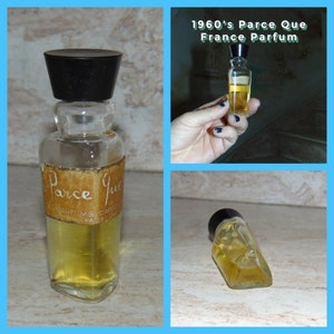 May include: A vintage glass bottle of Parce Que perfume from France. The bottle has a black plastic cap and a brown label with the words "Parce Que" and "Parfums Carolyne Paris".