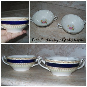 May include: Set of four vintage soup bowls with blue and gold trim. The bowls are white with a floral design and the words "Rare Sinclair by Alfred Meakin" are printed on the bottom.