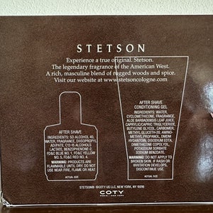 May include: A brown box with a white label featuring the Stetson logo and product information. The label includes the text "Experience a true original. Stetson." and "The legendary fragrance of the American West." The box contains two bottles of aftershave, one with a blue label and the other with a white label. The bottles are labeled "After Shave" and "After Shave Conditioning Gel".