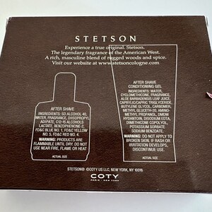 May include: A brown box with a Stetson cologne aftershave bottle and aftershave conditioning gel. The box has the Stetson logo and the text "Experience a true original. Stetson. The legendary fragrance of the American West. A rich, masculine blend of rugged woods and spice. Visit our website at www.stetsoncologne.com". The box also has the text "COTY Paris New York" on the bottom.
