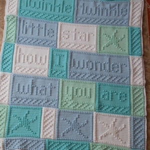 May include: A crocheted baby blanket in blue, green and white. The blanket features the lyrics to the song "Twinkle Twinkle Little Star" and a star design.