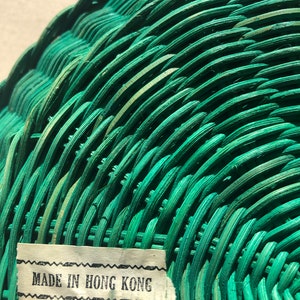 May include: A green wicker basket with a label that reads "MADE IN HONG KONG".