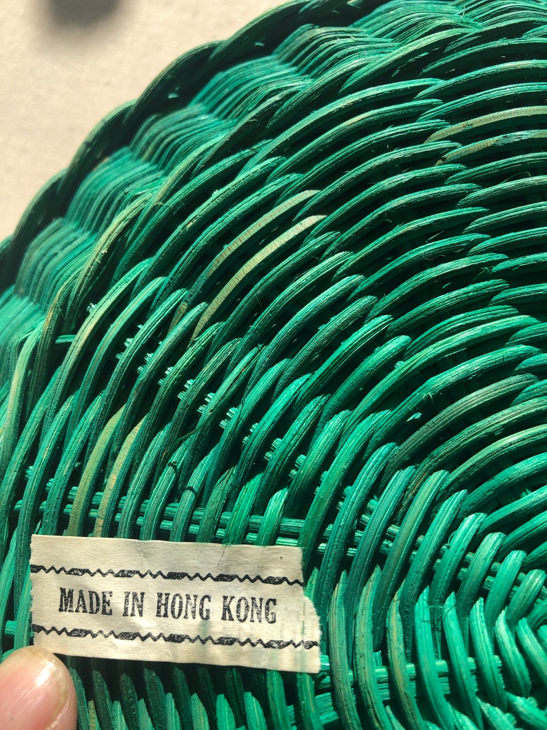 May include: A green wicker basket with a label that reads "MADE IN HONG KONG".