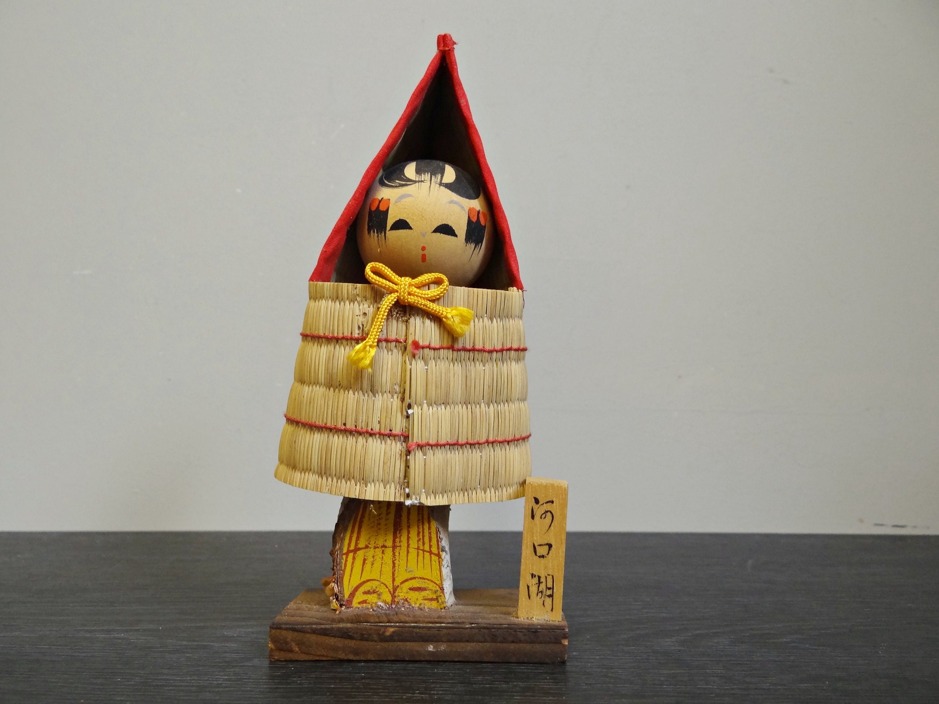 Rare old Kokeshi doll from Japan with straw rain cape, Vintage Kokeshi with traditional straw raincoat