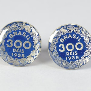 May include: Two blue and silver Brazilian coins with the text "BRASIL 300 REIS 1938" on each.