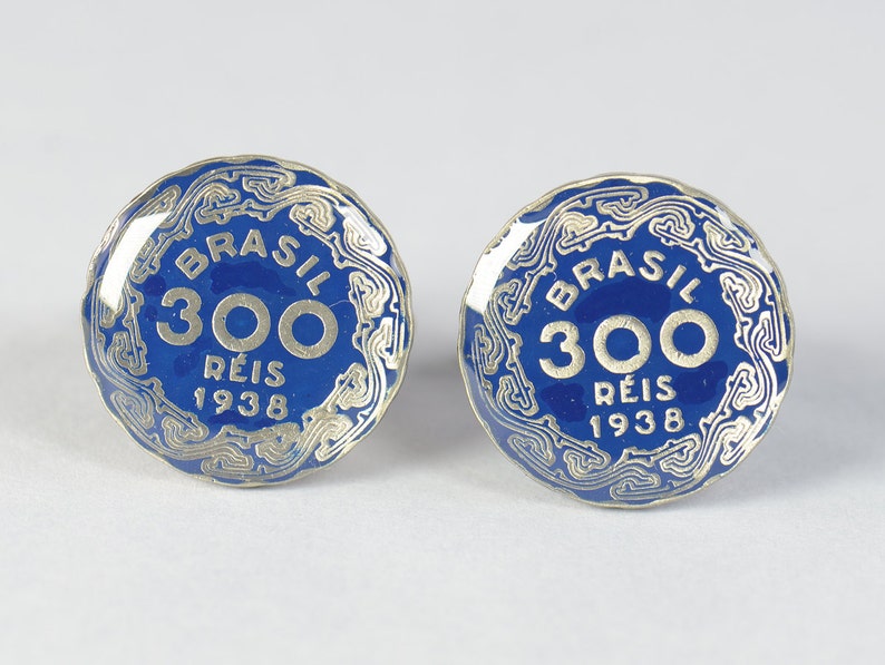 May include: Two blue and silver Brazilian coins with the text "BRASIL 300 REIS 1938" on each.