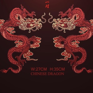 May include: Two embroidered red Chinese dragons facing each other on a dark red background. The dragons have intricate details with gold accents and cloud-like designs. The text at the bottom reads: W:27CM H:35CM CHINESE DRAGON.