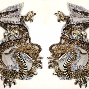 May include: Two embroidered dragon patches. Each dragon features gold, brown, and black thread detailing, with silver accents. The dragons are mirror images of each other, with intricate scales and clawed feet. The patches are likely for clothing or craft projects.