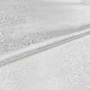 May include: White fabric with a repeating cloud-like pattern. The fabric is folded over, revealing a smooth, unpatterned surface. The design is a light, neutral color, suitable for various applications.