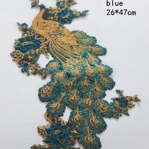 May include: A blue and gold peacock applique, 26 cm by 47 cm, with intricate sequin and embroidery details. The peacock features a detailed gold body and teal tail feathers, with floral accents.