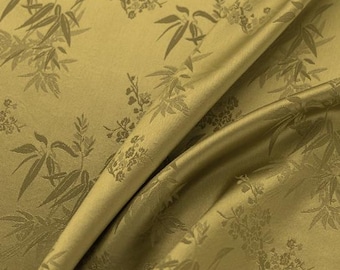 Tejido de triacetato de color amarillo oscuro con tejido jacquard de hojas de bambú, textura similar a la seda y satén.
