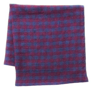 May include: A folded textile square featuring a repeating checkered pattern in deep burgundy and dark blue. The fabric displays a consistent woven texture throughout, with the grid design creating a uniform appearance across the entire surface area.