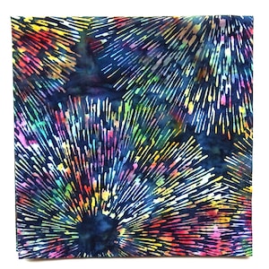 May include: A square piece of fabric featuring a dark navy blue background with a vibrant, multi-colored pattern of radiating lines that resemble fireworks or starbursts in shades of yellow, pink, green, orange, and light blue throughout.
