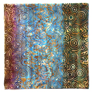 May include: A square fabric piece featuring a batik-style pattern with concentric circles and wavy lines. The design incorporates a vibrant color palette of bright blue, deep brown, golden yellow, and hints of purple and green throughout the surface.