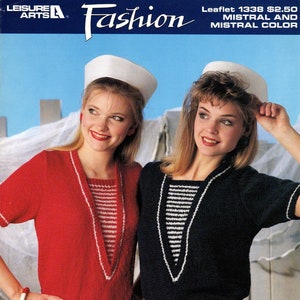 May include: Two women wearing sailor hats and white pants. One woman is wearing a red sweater with white stripes and the other is wearing a navy blue sweater with white stripes. The sweaters have a V-neck design. The text "Leaflet 1338 $2.50 MISTRAL AND MISTRAL COLOR featuring nomotta MISTRAL" is at the bottom of the image.