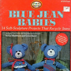 May include: A book cover with a red background and the title "Blue Jean Babies: 14 Soft-Sculpture Projects That Recycle Jeans". The cover features two blue jean teddy bears, one wearing a pink ribbon and the other wearing overalls. The book includes full-color step-by-step construction photos.