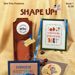 May include: A cross-stitch pattern book titled "Shape Up!" with three different designs. The first design is a wooden plaque with a cross-stitch of a person running. The second design is a cross-stitch of a person with a thought bubble that says "Today is the first day of the rest of my diet." The third design is a cross-stitch of a person exercising with the text "Exercise gets it all together in the right places."