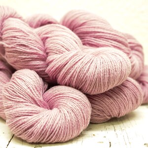 May include: A pile of soft, pink yarn, perfect for knitting or crocheting.
