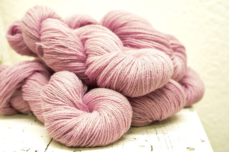May include: A pile of soft, pink yarn, perfect for knitting or crocheting.