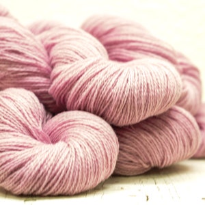 May include: A pile of soft, pink yarn, perfect for knitting or crocheting.