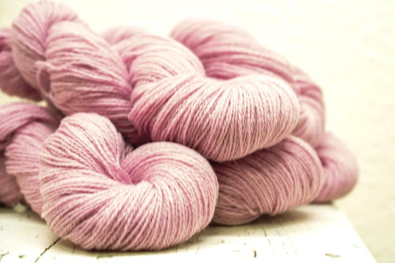 May include: A pile of soft, pink yarn, perfect for knitting or crocheting.