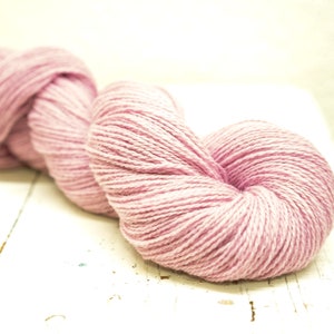 May include: A skein of soft, pink yarn, perfect for knitting or crocheting.