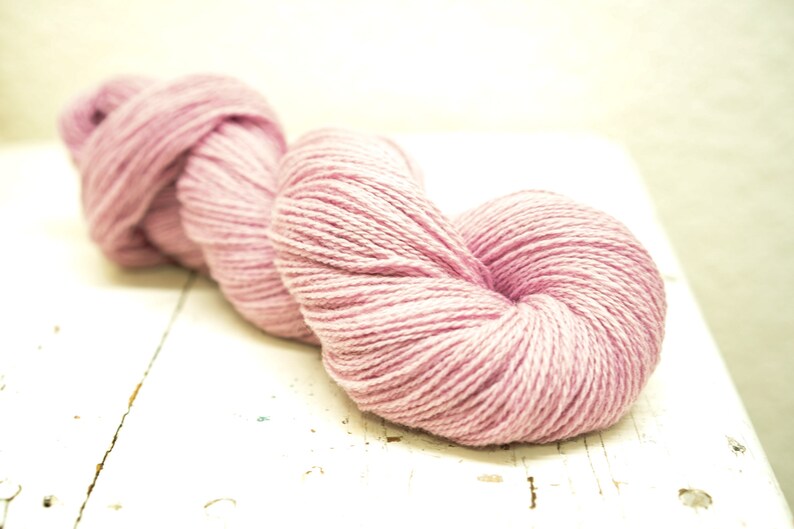 May include: A skein of soft, pink yarn, perfect for knitting or crocheting.