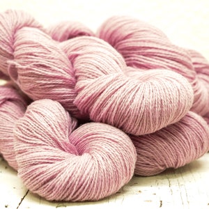 May include: A pile of soft, pink yarn, perfect for knitting or crocheting.