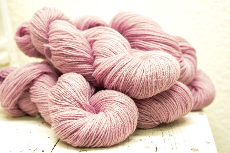 May include: A pile of soft, pink yarn, perfect for knitting or crocheting.