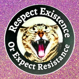 May include: A round sticker with a cat's face, mouth open in a roar, surrounded by the text "Respect Existence Or Expect Resistance." The cat has brown and tan fur, with a pink tongue. The background is a sparkly, glittery pink.