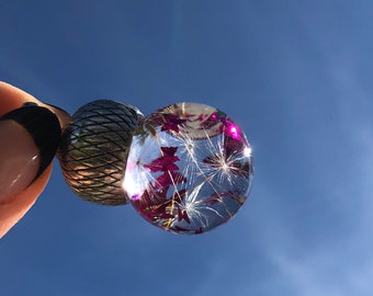 Glass bead filled with transparent oil real dandelions and butterflies