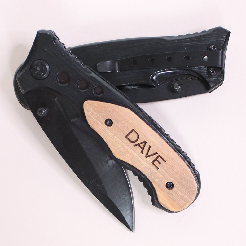 May include: A black pocket knife with a wooden handle engraved with the name "DAVE".