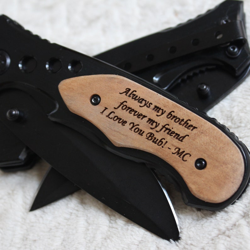 May include: Black pocket knife with a wooden handle engraved with the message "Always my brother forever my friend I Love You Bub! -MC"