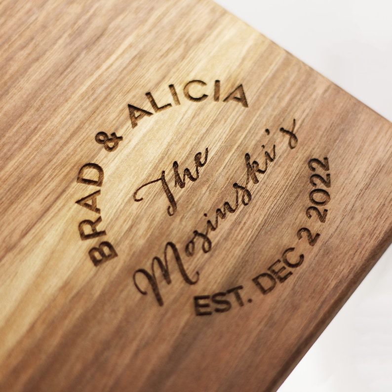 May include: A wooden cutting board with the text "Brad & Alicia The Majinski's Est. Dec 22 2022" engraved in a circle.