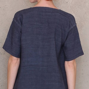May include: A dark blue, short-sleeved t-shirt with a scoop neck.