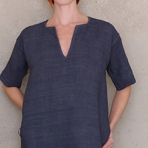 May include: A dark blue linen tunic with a v-neckline and short sleeves.