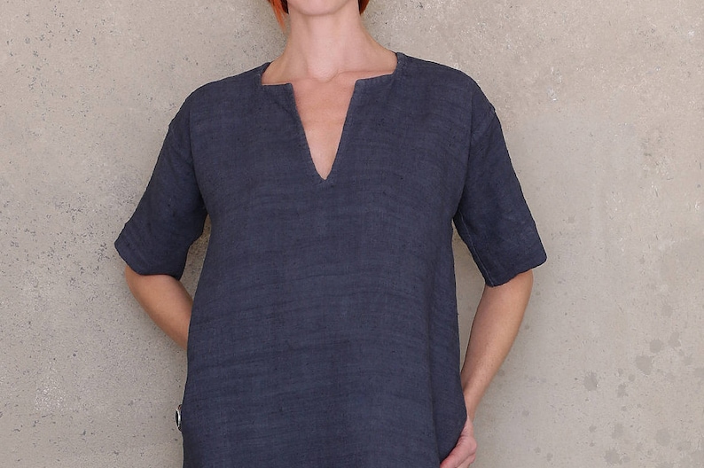 May include: A dark blue linen tunic with a v-neckline and short sleeves.