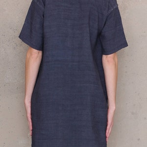 May include: A dark gray, short-sleeved, linen dress with a scoop neck.