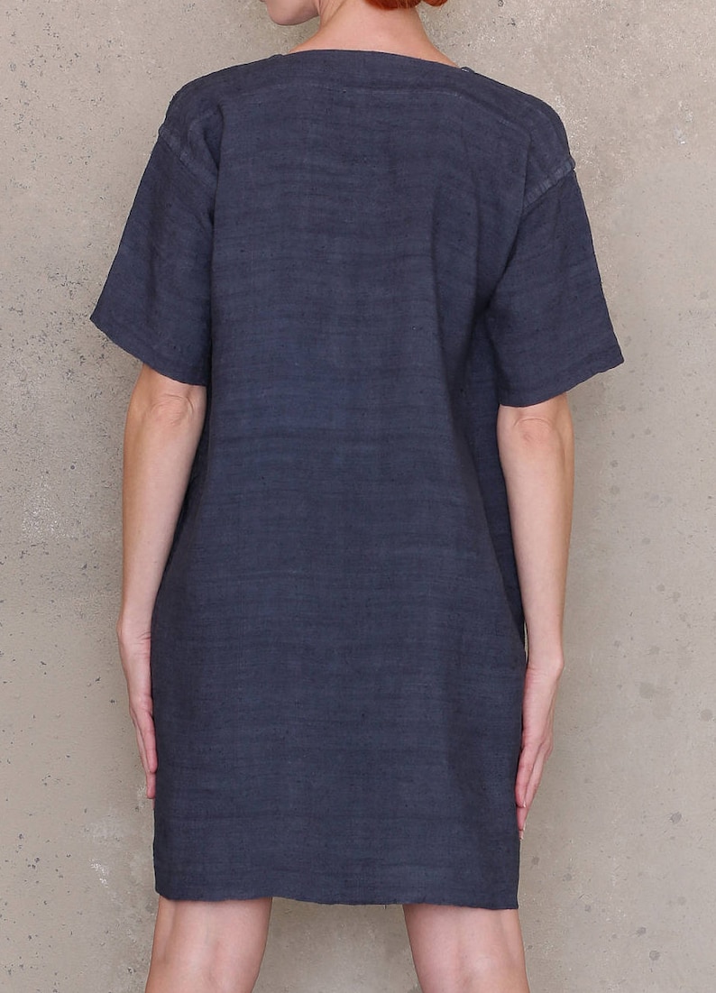 May include: A dark gray, short-sleeved, linen dress with a scoop neck.