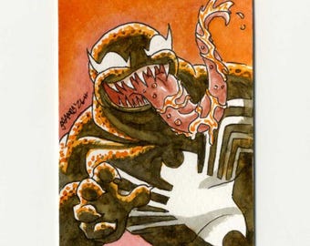 May include: A rectangular art print featuring a stylized illustration of a dark, monstrous creature with a wide, toothy grin and a long, protruding tongue. The figure is rendered in shades of black and orange against a vibrant orange background.
