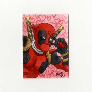 May include: A watercolor illustration of Deadpool, a superhero, wearing a red and black suit with a gold belt. He is making a peace sign with his fingers and has a pink background with hearts.