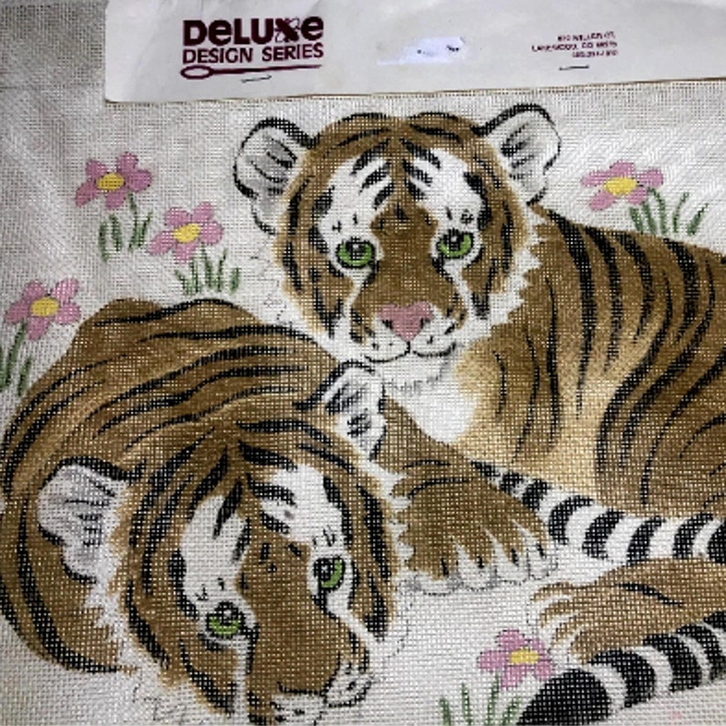 Here is a cute needlepoint kit of two baby bengal cubs. It is crated by the Deluxe design series. The little wild cats are resting among wildflowers.