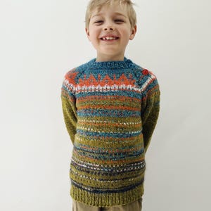 Hand knitted child Icelandic Style Fair Isle sweater in warm green with a bright blue and orange Fair Isle pattern