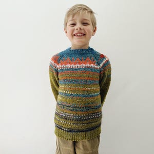 Hand knitted child Icelandic Style Fair Isle sweater in warm green with a bright blue and orange Fair Isle pattern