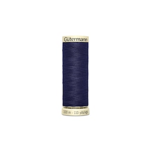 May include: A spool of dark blue Gütermann thread with a label that reads "Gütermann" and "100 m - 110 yds/vgs".