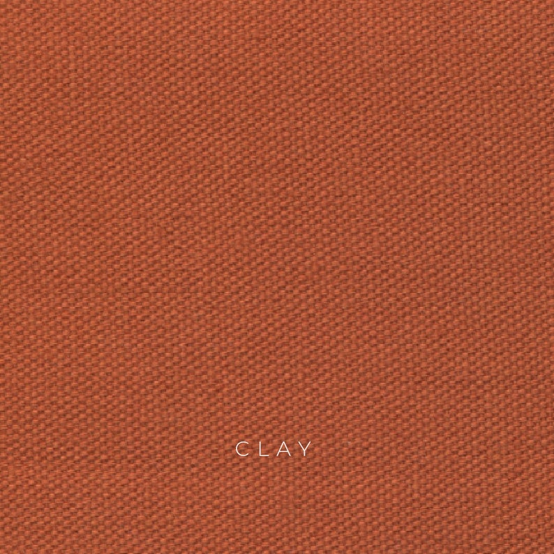 Clay organic cotton canvas is a sun baked orange color and has a coarse texture. The fabric is made from organic cotton fibers that are woven together in a plain weave. The fabric is durable, breathable and eco-friendly.